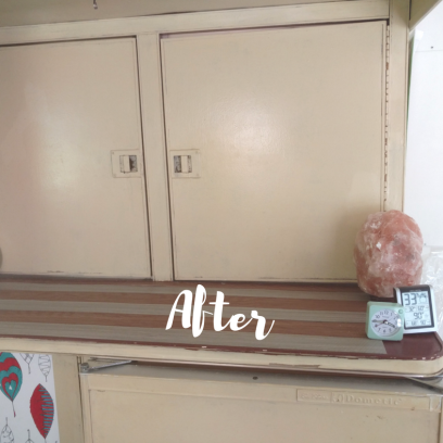 After photo of kitchen counter of 1974 Airstream Argosy before remodeling. Contains all the original Airstream parts. Painted with cream Milk Paint, Marmolem wood-grain strips on counter, pink salt lamp, clock and humidity monitor pictured as well as leaf coloring wallpaper.